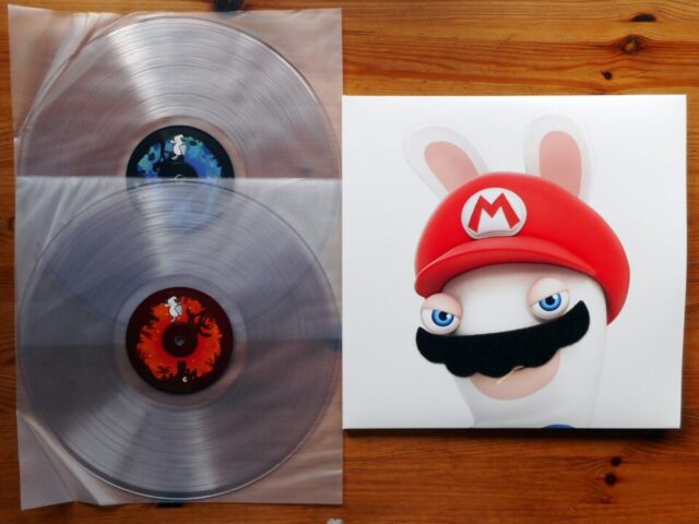 Album: Mario + Rabbids Kingdom Battle
Artist(s): @grantkirkhopecomposer
Label: @iam8bit, 2018
Games: Mario + Rabbids Kingdom Battle

Back in 2017 we learned that some guys at @Ubisoft had somehow managed to convince @Nintendo that a crossover between the Rabbids and Super Mario franchise was a good idea. Even more baffling was that it was a turn-based strategy and... it's actually quite good.

The soundtrack is composed by the legendary Grant Kirkhope who was reportedly asked to write the score before being told that it would be a Mario game and was rather awe-struck upon finding out. Nevertheless it turned out to be good choice as Kirkhope's experience writing music for wacky games proved a great fit for the crazy Rabbids. The compositions are all performed excellenty by The City of Prague Philharmonic Orchestra. Some of my personal favorites are "Cold Start, Hot Finish", which harkens back to some of Kirkhope's past scores, the epic and powerful "The Lava Forge", and the big star of the show the multi-act "The Phantom Of The Bwahpera". As a neat bonus game director Davide Soliani snuck a vinyl only bonus track of a demo of the Phantom-song sung by Kirkhope himself as well.

The release itself was put out by iam8bit and while there's no original art used (to my knowledge) they use the game assets well for a simple front and back and a colorful gatefold image. The front features the best part of the release's design where they slapped an actual fuzzy mustache on Rabbid Mario, which is one of my favorite jacket gimmicks in my entire collection. It comes on clear vinyl and it's a fairly quiet pressing and I didn't personally notice many flaws, although there are reports of some people having a slightly muddy sound on theirs - so your mileage may vary. It's also probably the easiest of any Mario-related vinyl releases to track down for a decent price!

#vinyl #instavinyl #vgmvinyl #vgm #videogamemusic #gaming #blipblop #records #gamemusic #soundtrack #music #videogamevinyl #vinylcollector #vinylcollection #vinylrecords #nowspinning #nowplaying #nowlistening #vinyljunkie #vinyligclub #igvinyl #grantkirkhope #mariorabbids #ubisoft #iam8bit #supermario